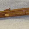 left side fullsize rifle carved from walnut all the inlays are oak. This  is a  replica of 50 caliber black powder rifle. 