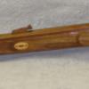 left side fullsize rifle carved from walnut all the inlays are oak. This  is a  replica of 50 caliber black powder rifle. 